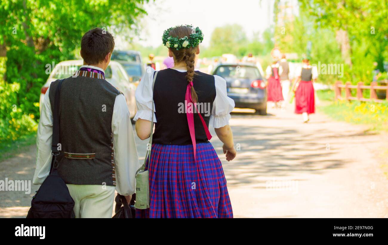 Zwei lettische Tänzer in Nationalkostüm gehen zum Konzert. Stockfoto