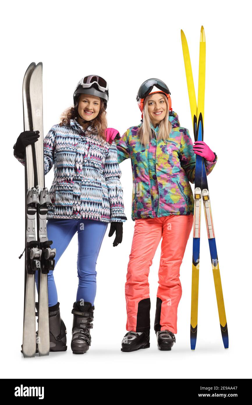 Ganzkörperportrait von zwei jungen Frauen im Ski Uniformen isoliert auf weißem Hintergrund Stockfoto