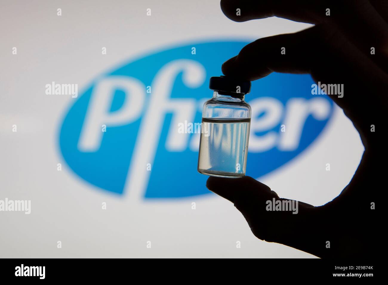 OXFORD, Großbritannien - Februar 2020: Eine kovidierte Impfstoffflasche vor dem pfizer-Logo Stockfoto