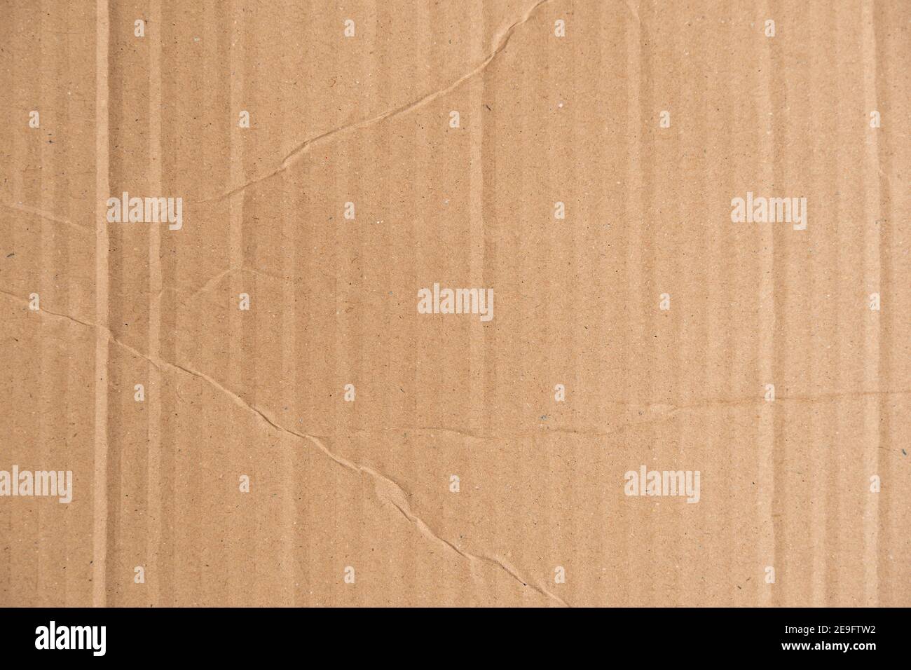 Braune Wellpappe Textur mit Falten und Falten. Kartonstruktur einer Verpackungsbox, die für Versand und Lieferung verwendet wird. Beschädigtes Paket Stockfoto