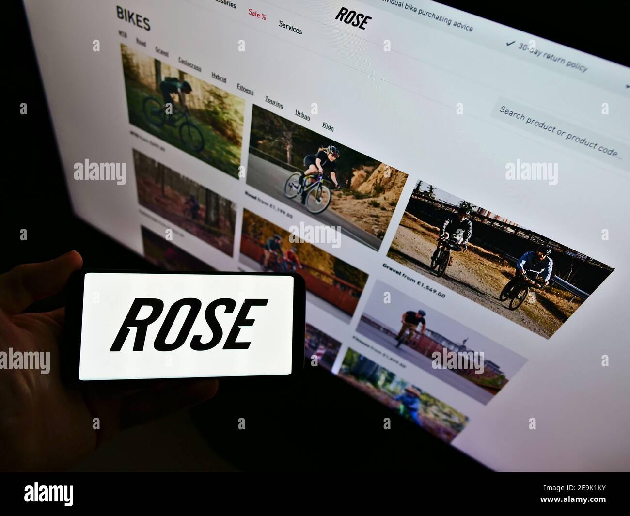 Person, die Smartphone mit Logo des deutschen Fahrradherstellers Rose Bikes GmbH vor der Business-Website hält. Fokus auf Telefonbildschirm. Stockfoto