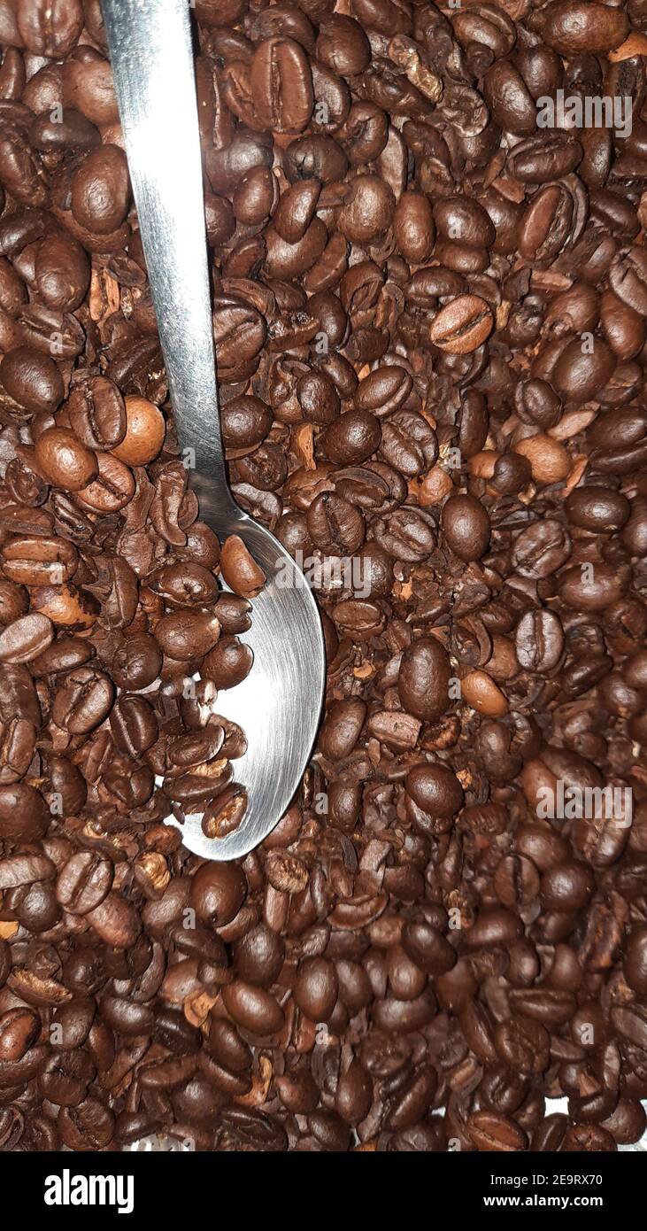 Löffel in Kaffeebohnen Stockfoto