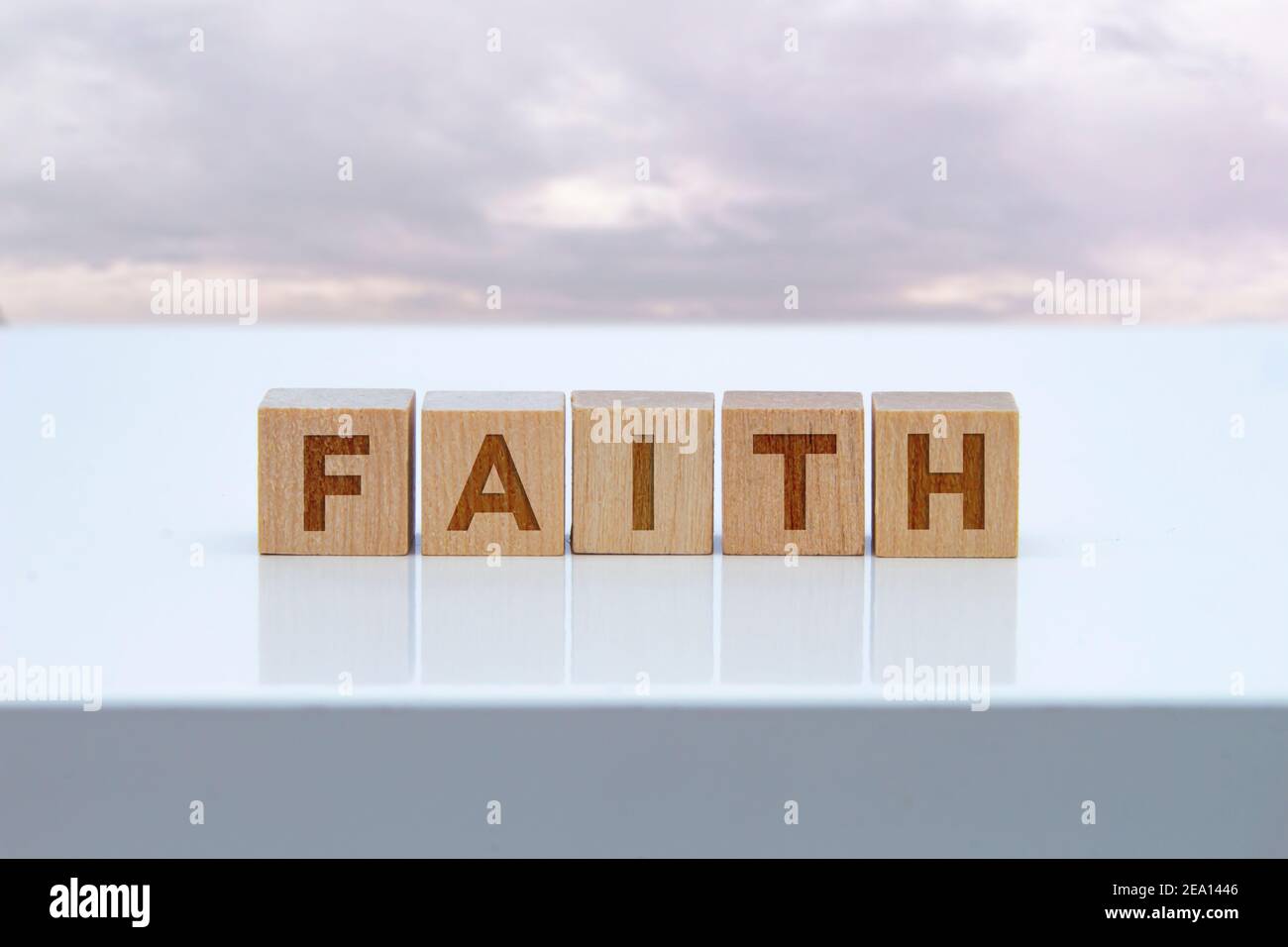 'Faith'-Schild auf Holzblöcken auf einem weißen Tisch. Stockfoto