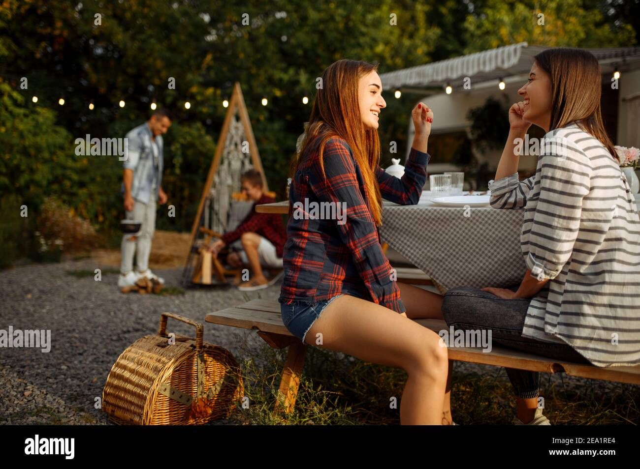 Junge Freunde entspannen sich beim Picknick beim Camping Stockfoto