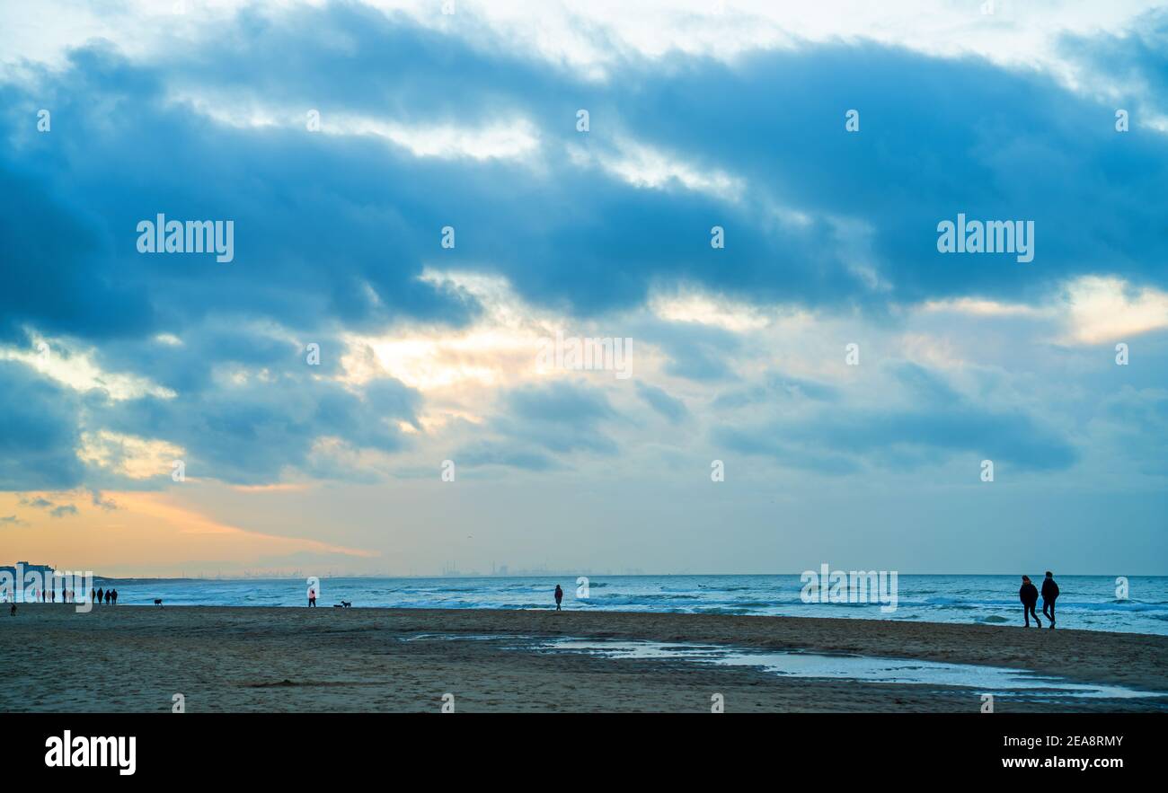 Menschen am Strand bei Sonnenuntergang Stockfoto