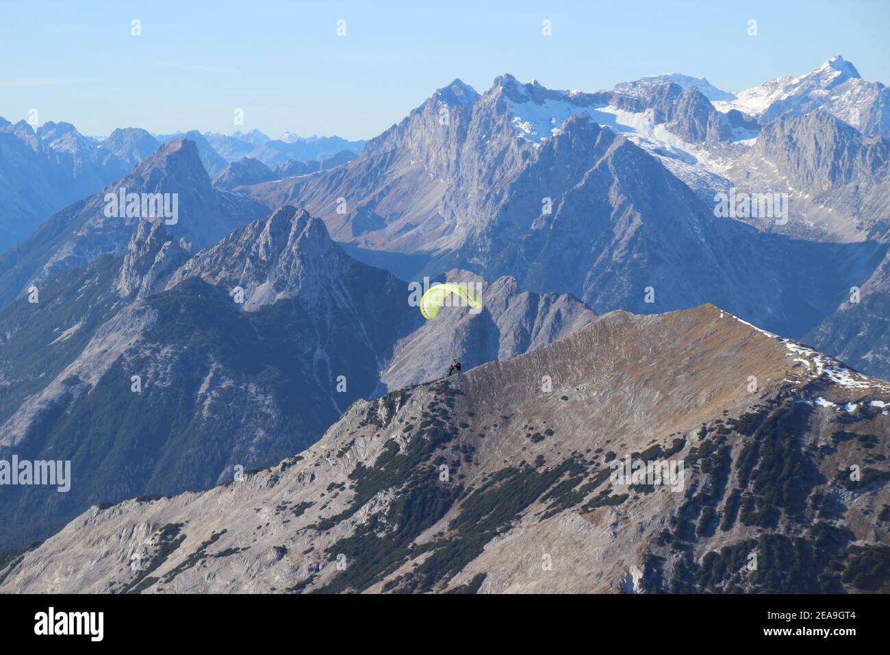 Wanderung zur Pleisenspitze (2569m), Paragleiter, vor dem Brunnsteinmassiv, in der Mitte hinter dem Wettersteingebirge, im Hintergrund die Zugspitze, Bergtour, Bergwandern, Outdoor Stockfoto