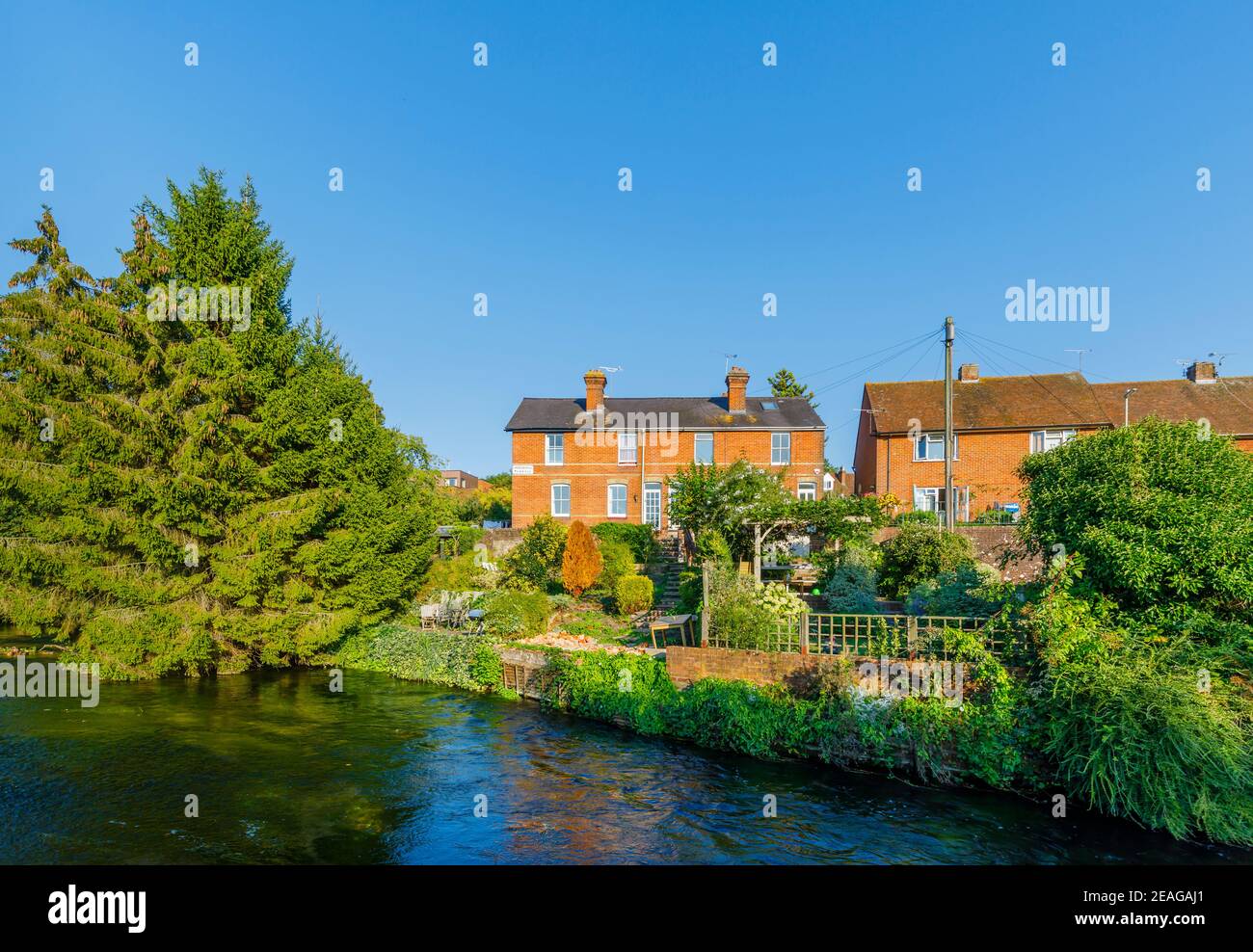 Angenehme Rückansicht der roten Backsteinhäuser mit Blick auf den Fluss Itchen an den Wehren in Winchester, Hampshire, Südengland, Großbritannien Stockfoto