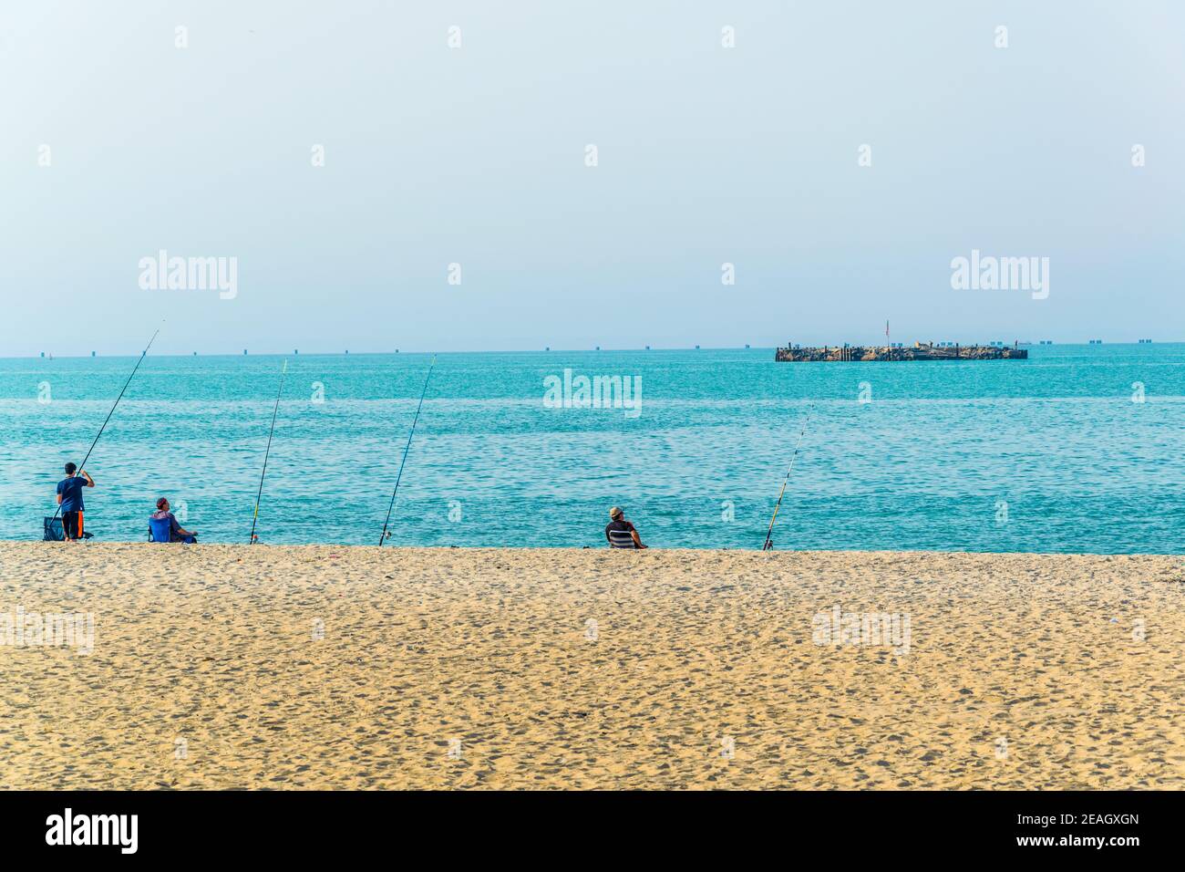 Menschen sitzen an einem Strand in Kuwait Stockfoto