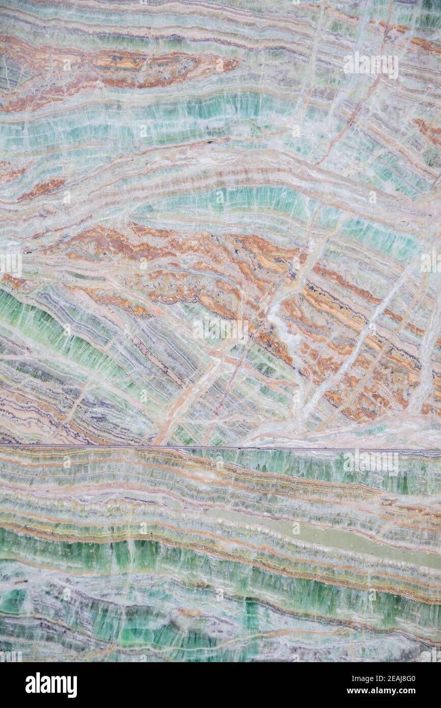 Porträtansicht einer Marmorwand mit einer Kombination von Grün und Orange Farben Stockfoto