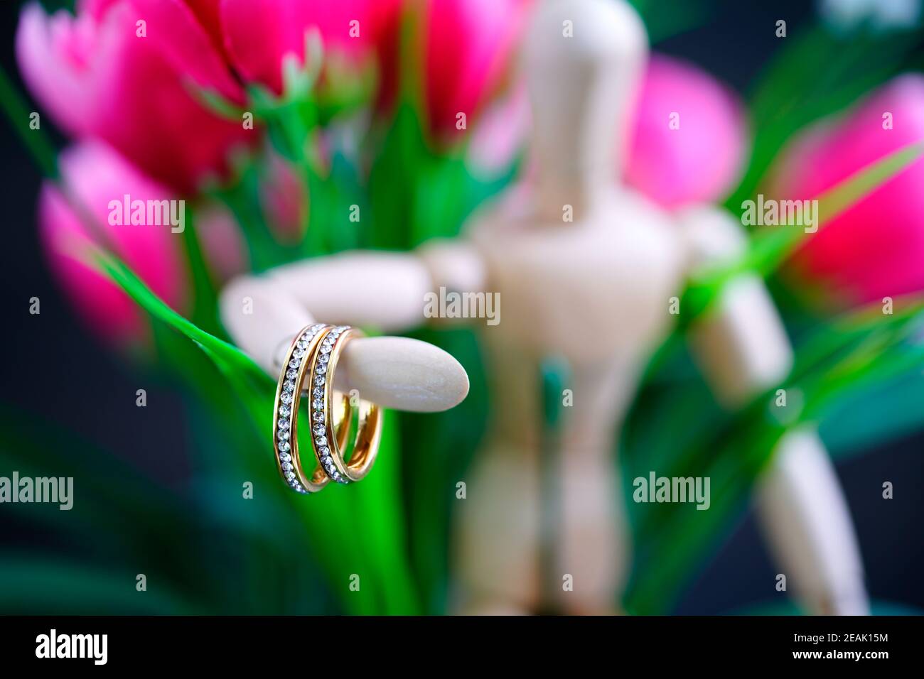 Holzfigur mit zwei goldenen Ehering Stockfoto