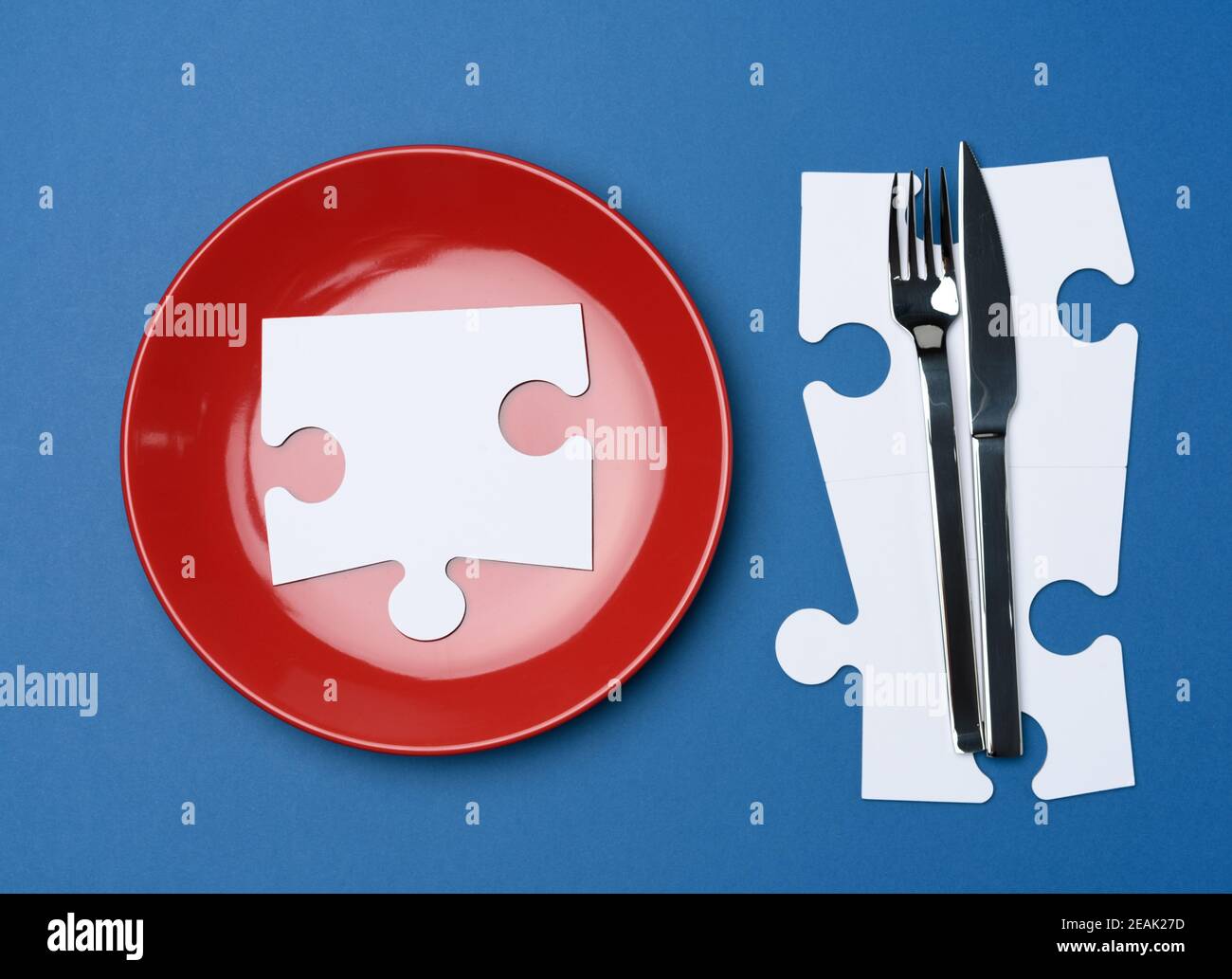 Rote runde Keramikplatten, Gabel mit Messer auf blauem Hintergrund Stockfoto