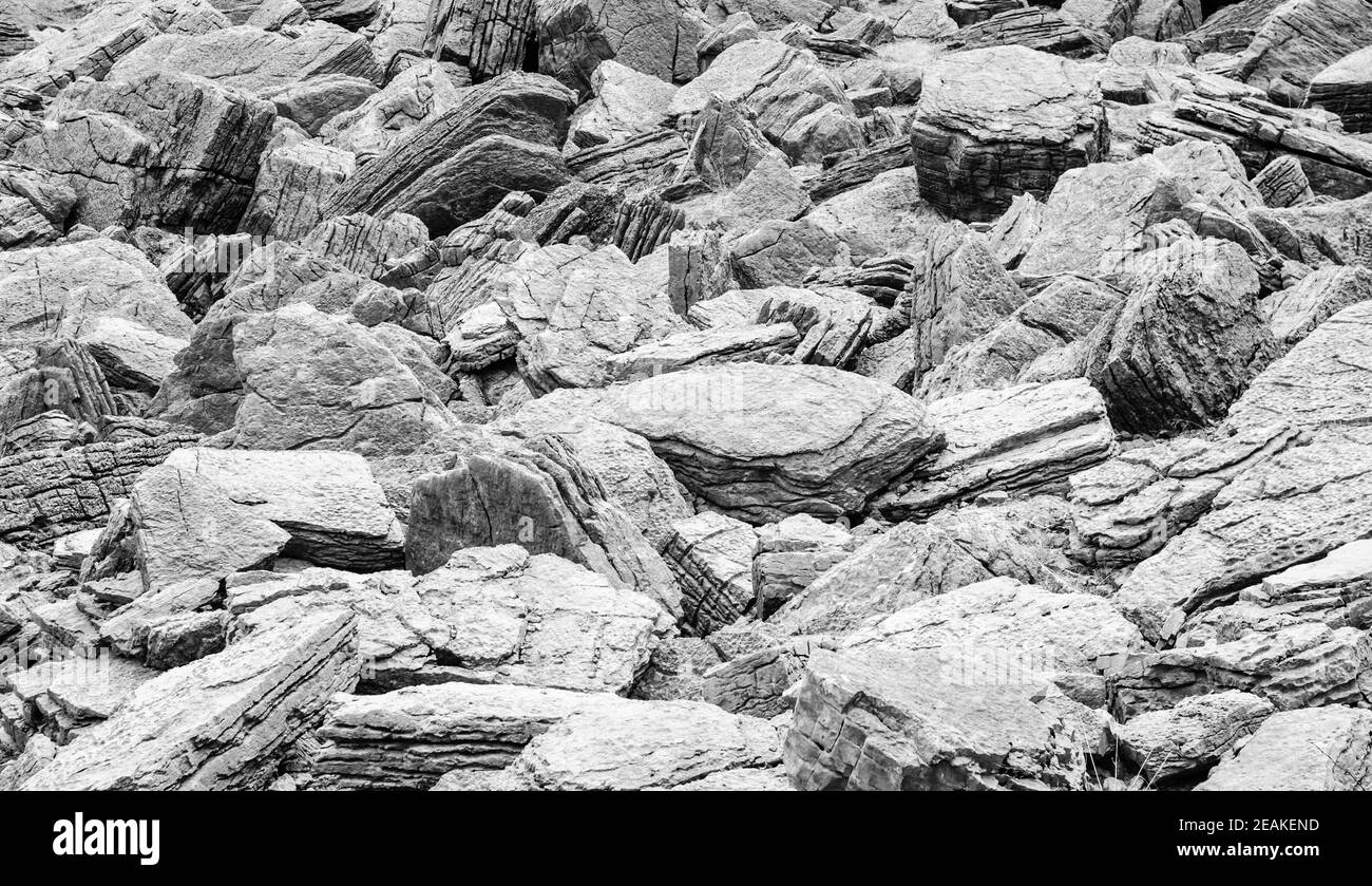 Abstraktes Gewirr aus grauen, strukturierten Steinen. Stockfoto