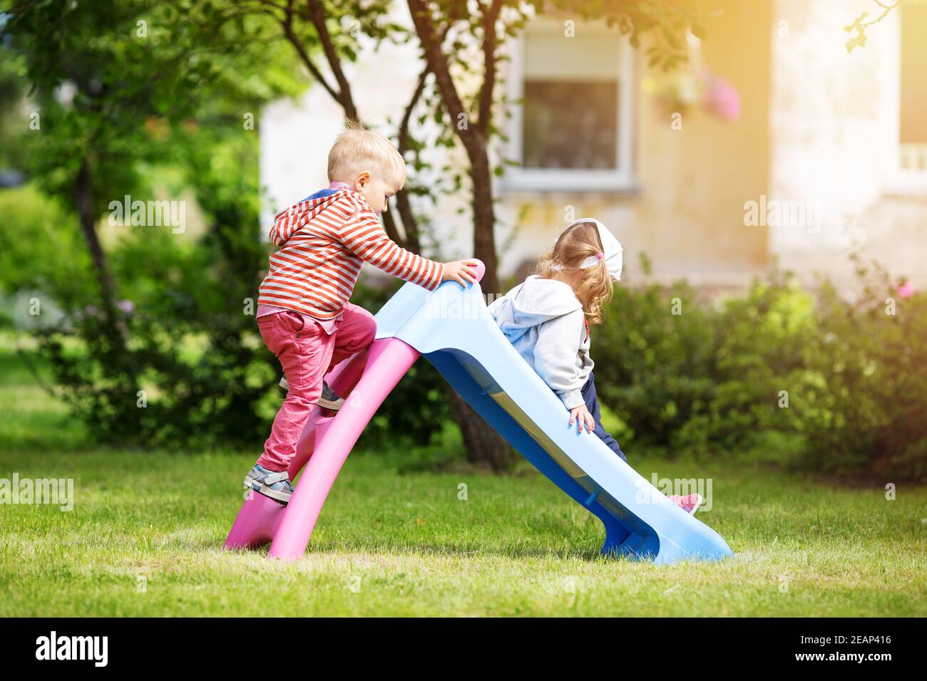 Junge und Mädchen spielen auf dem Hinterhof Stockfoto