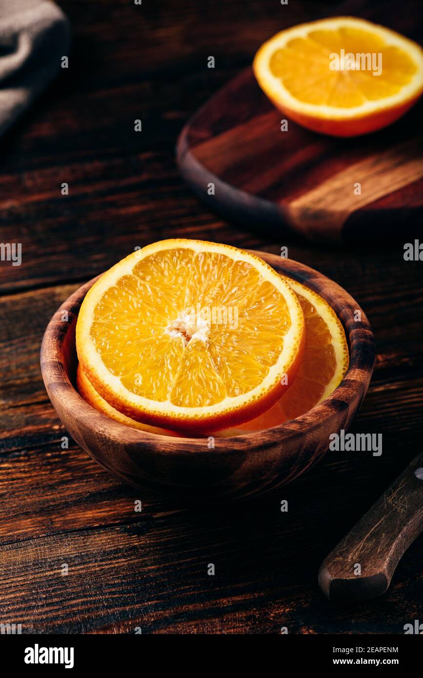 Orange in einer Holzschale geschnitten Stockfoto