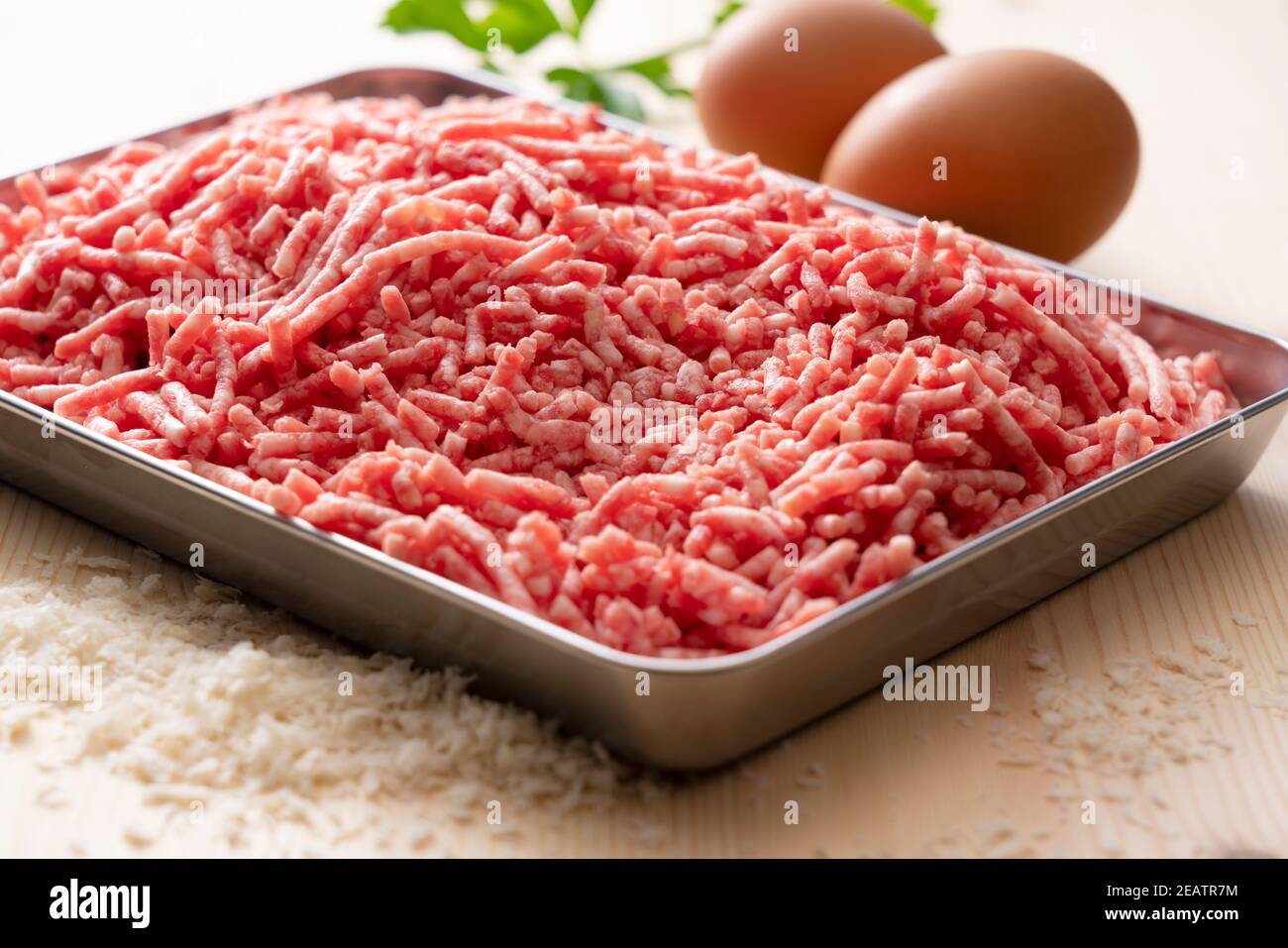 Hackfleisch und Eier in einem Tablett auf einem hölzernen Hintergrund Stockfoto