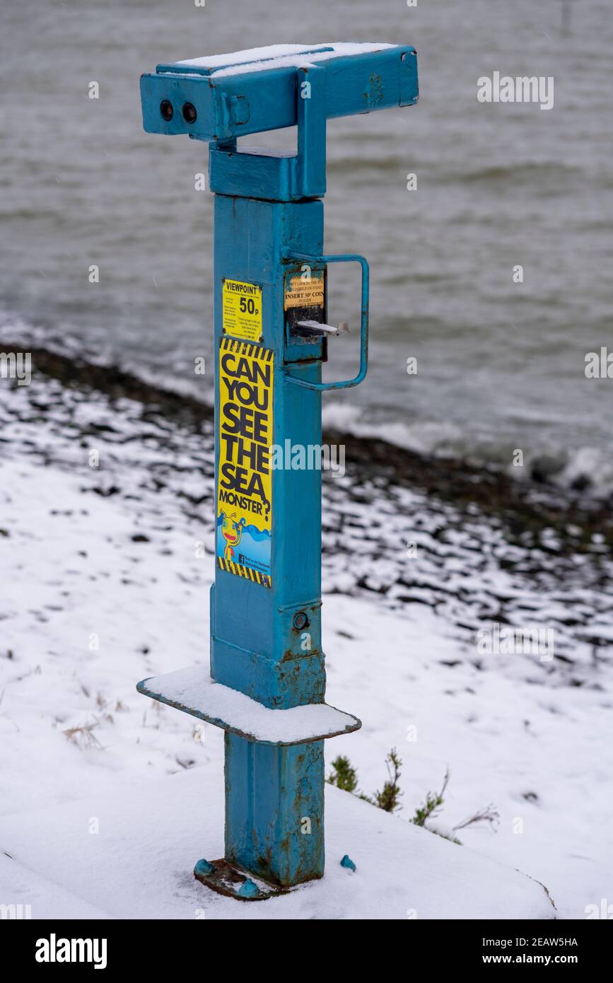 Altes Münzfernrohr an der Küste in Southend on Sea, Essex, Großbritannien, mit Schnee von Storm Darcy. Können Sie das Meer sehen Stockfoto