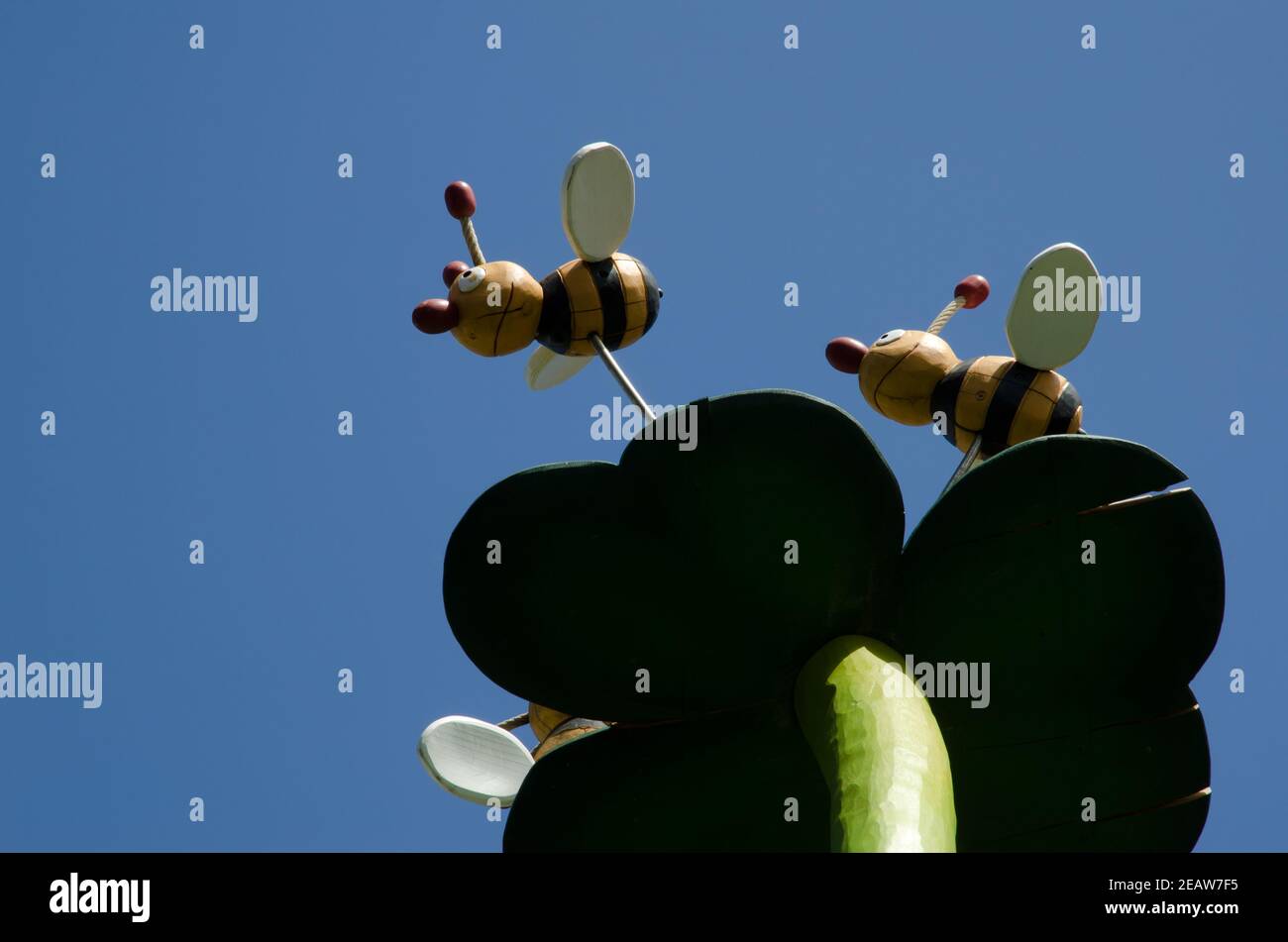 Skulptur, die eine Blume und zwei Bienen darstellt. Stockfoto