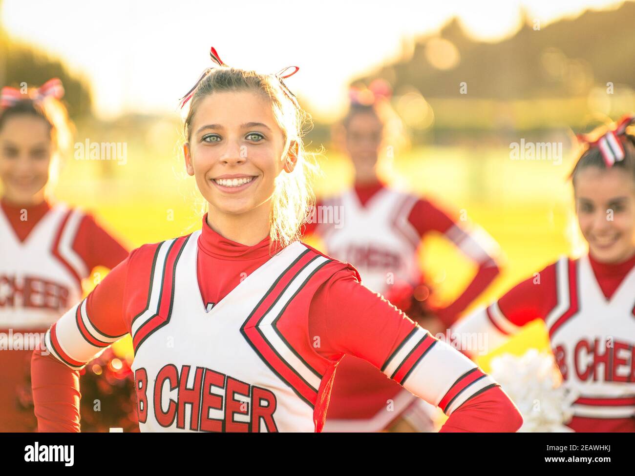 Portrait eines glücklichen jungen Cheerleaders in Aktion im Freien - Gruppe von Freundinnen während Cheerleading Sport Training an der High School Stockfoto