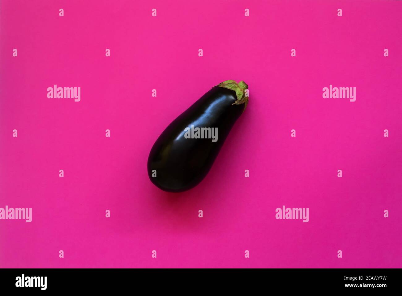 Aubergine isoliert in einem fuchsienfarbenen Hintergrund von oben gesehen - Flatlay-Optik Stockfoto