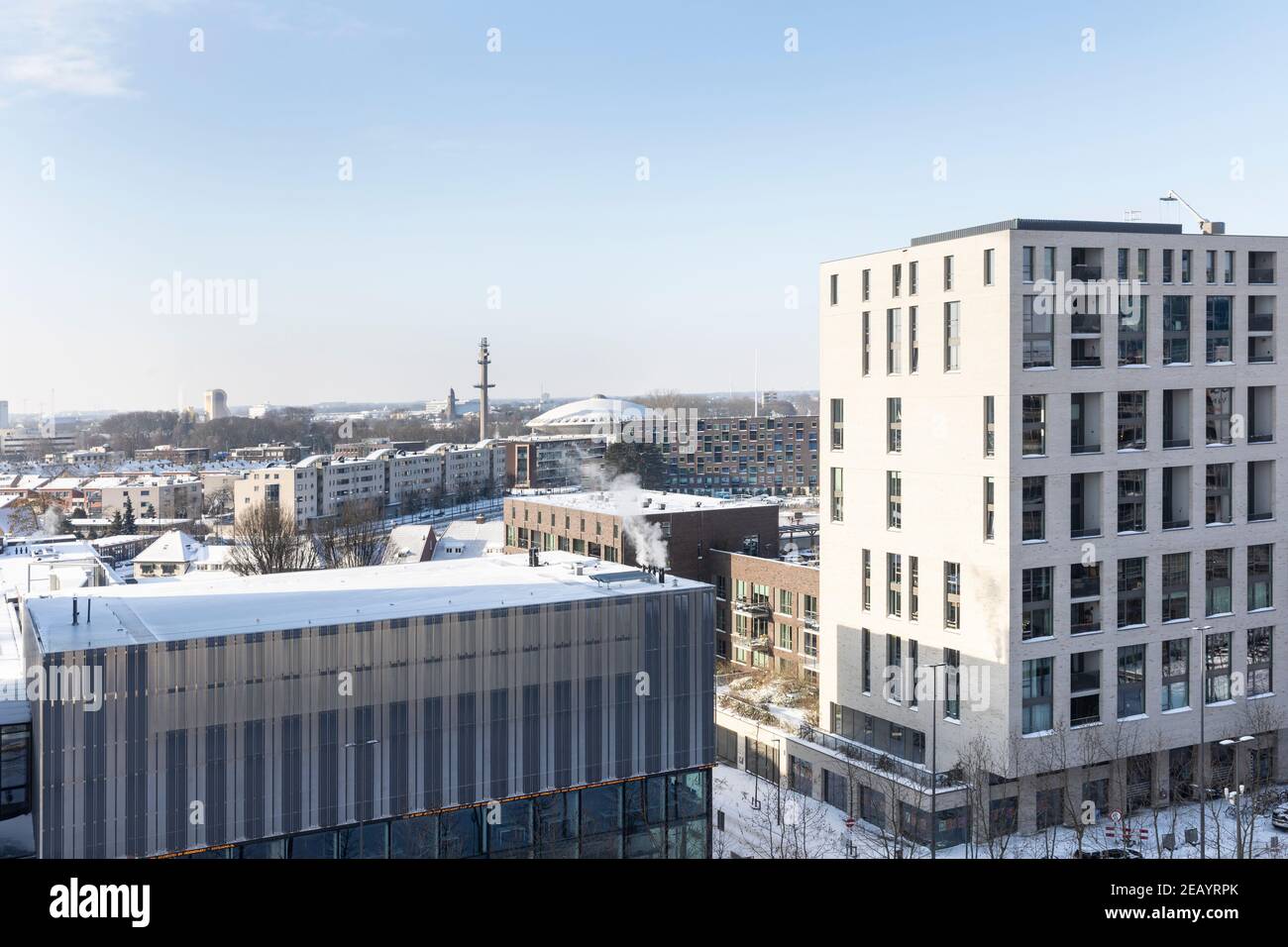 Eindhoven, Niederlande, 9th. Februar 2021. Strijp S Blick auf die Stadt mit dem Evoluon und schneebedeckten Gebäuden an einem kalten sonnigen Tag und einem blauen Himmel Stockfoto