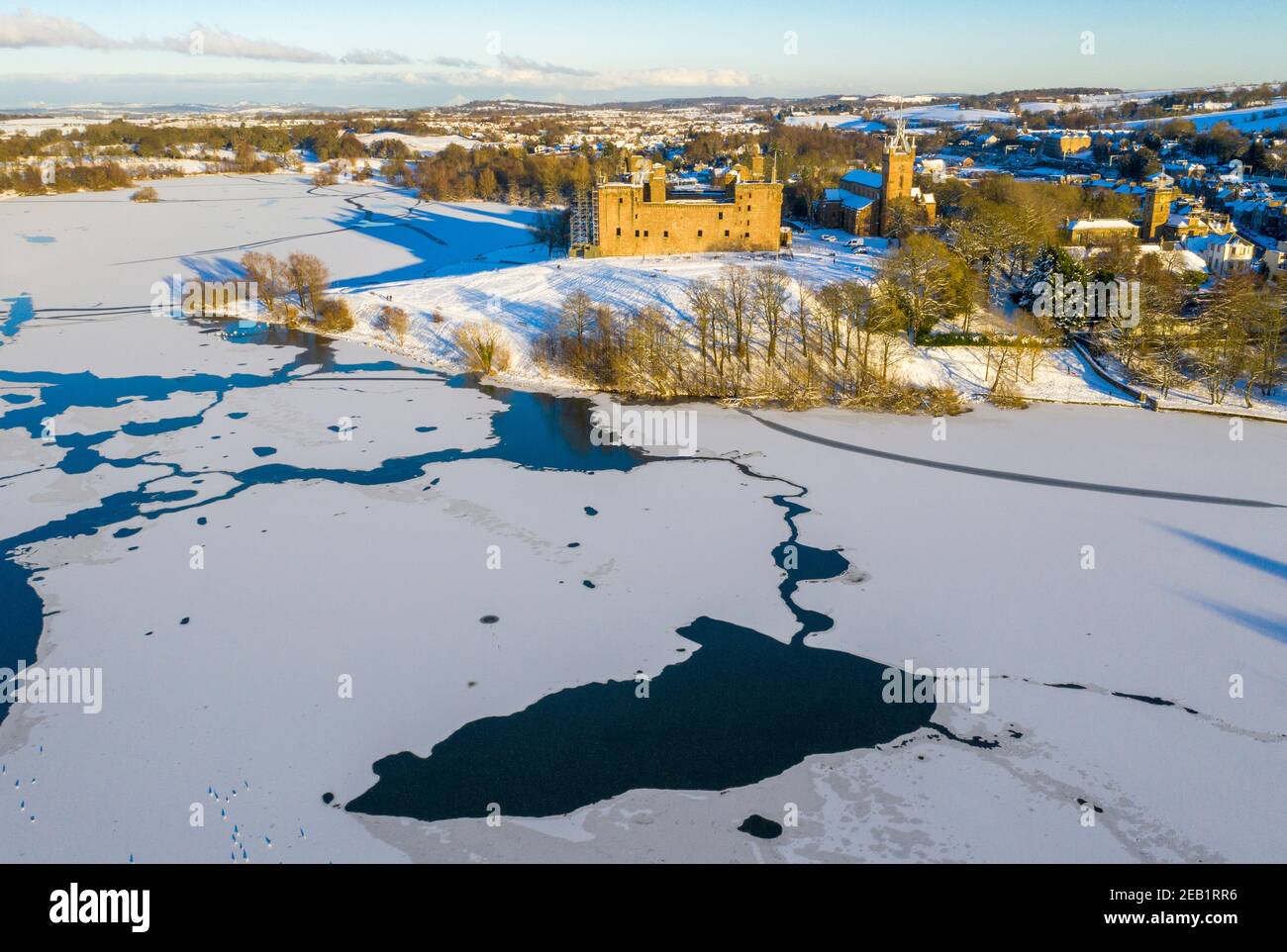 Winterszene Schottland: Luftaufnahme des Sonnenuntergangs auf Linlithgow Palace und Linlithgow Loch. Stockfoto