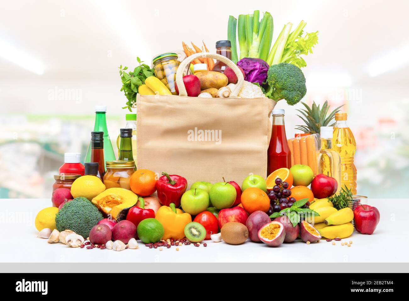 Farbenfrohe Lebensmittel und Lebensmittel, darunter frisches Obst und Gemüse Weiße Arbeitsplatte im Supermarkt Hintergrund Stockfoto