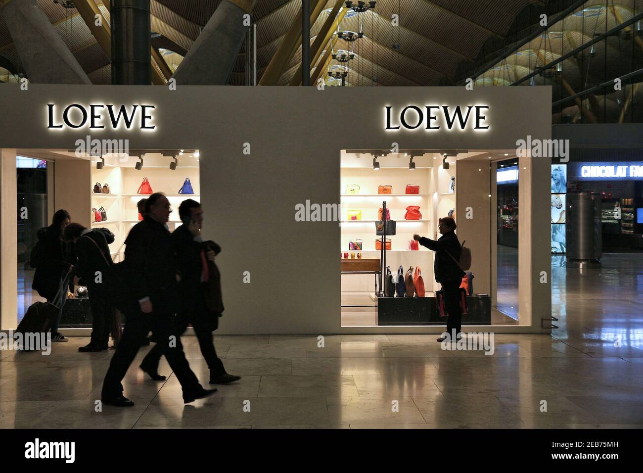 MADRID, SPANIEN - 6. DEZEMBER 2016: Passagiere besuchen Loewe Fashion Shop am Flughafen Madrid in Spanien. Es ist der 6. Verkehrsreichste Flughafen in Europa, mit 50.4 m Stockfoto