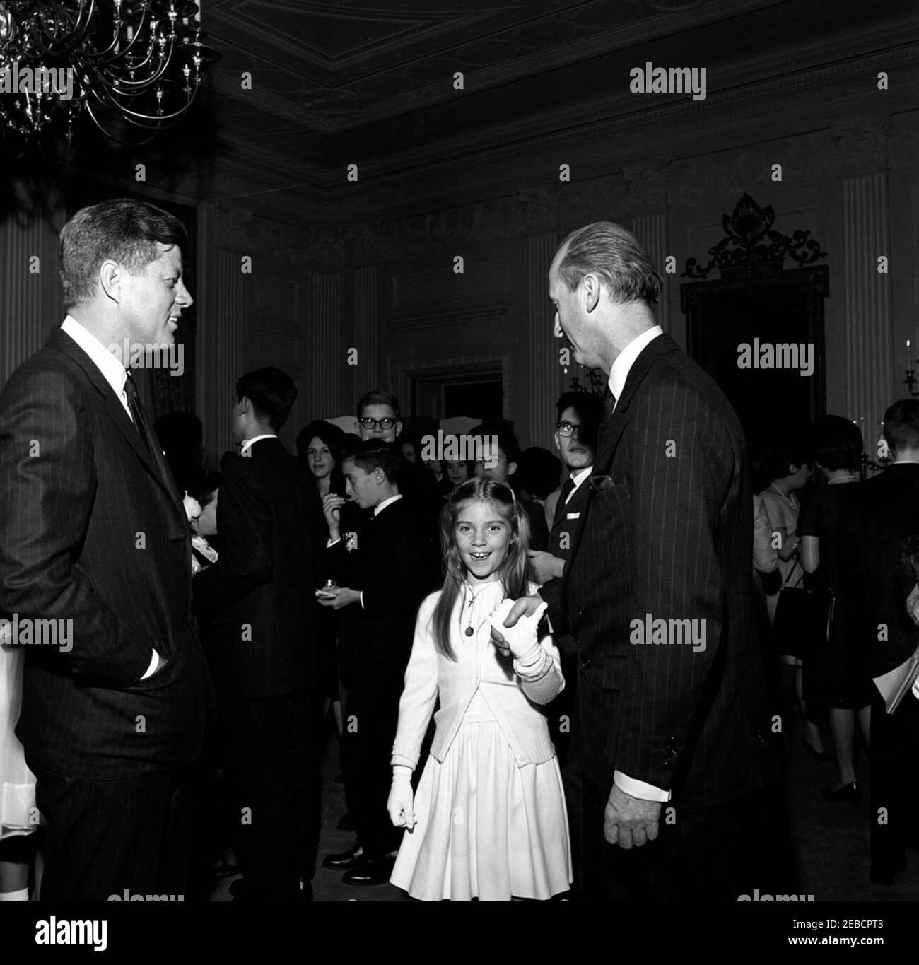 First Lady Jacqueline Kennedyu0027s (JBK) zweites Musikprogramm für Jugendliche: Metropolitan Opera führt eine Auswahl von Mozartu2019s Cosu00ec Fan Tutte. Präsident John F. Kennedy besucht den Protokollführer Angier Biddle Duke und seine Tochter Maria-Luisa Biddle Duke nach der Vorstellung der Metropolitan Opera Studiou2019s von Mozartu2019s u201cCosu00ec Fan tutteu201d im Weißen Haus. First Lady Jacqueline Kennedy hielt die Veranstaltung für Kinder von Botschaftern in Washington, D.C., es war das zweite ihrer musikalischen Programme für die Jugend. State Dining Room, White House, Washington Stockfoto