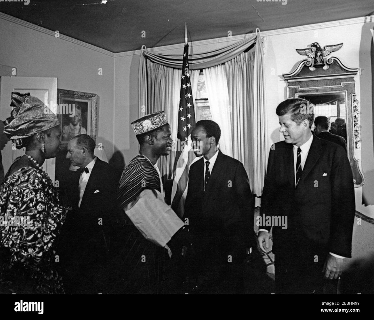 Empfang zu Ehren von Präsident Kennedy, gegeben von Julius Nyerere, Präsident von Tanganyika, 6:20pm Uhr. Präsident John F. Kennedy (ganz rechts) nimmt an einem Empfang Teil, der von Präsident von Tanganyika, Julius Nyerere (zweiter von rechts), in der Residenz des US-Protokollchef Angier Biddle Duke zu seinen Ehren gegeben wurde. Andere sind nicht identifiziert. Washington, D.C. Stockfoto