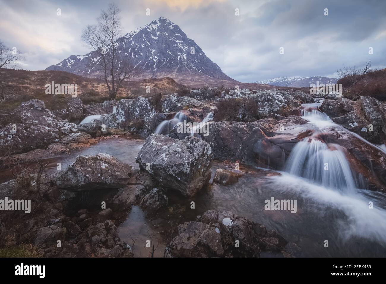 Moody Landschaft des berühmten Buachaille Etiv Mor und River Coupall Wasserfall in Glencoe in den schottischen Highlands. Stockfoto