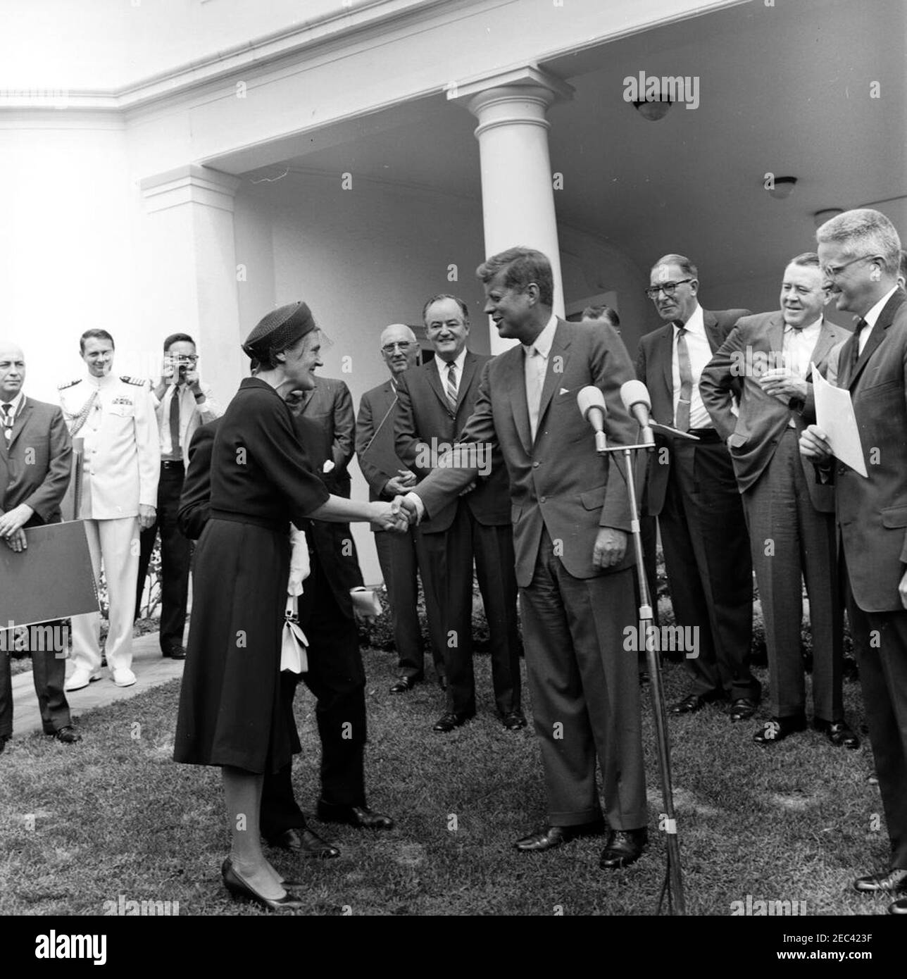 Verleihung der Distinguished Civilian Service Awards Presidentu2019s, 12:00pm Uhr. Verleihung des Preises Presidentu2019s für den ausgezeichneten Zivildienst des Bundes. Präsident John F. Kennedy schüttelt sich die Hände mit Dr. Frances Oldham Kelsey (links), dem medizinischen Beauftragten der Food and Drug Administration (FDA), bevor er ihr die Auszeichnung überreicht; der Sekretär des Ministeriums für Gesundheit, Bildung und Wohlfahrt (HEW), Anthony J. Celebrezze (größtenteils versteckt), steht hinter Dr. Kelsey. Looking On (L-R): Preisträger und Direktor des bemannten Raumfahrtzentrums, Dr. Robert Gilruth; Naval A Stockfoto