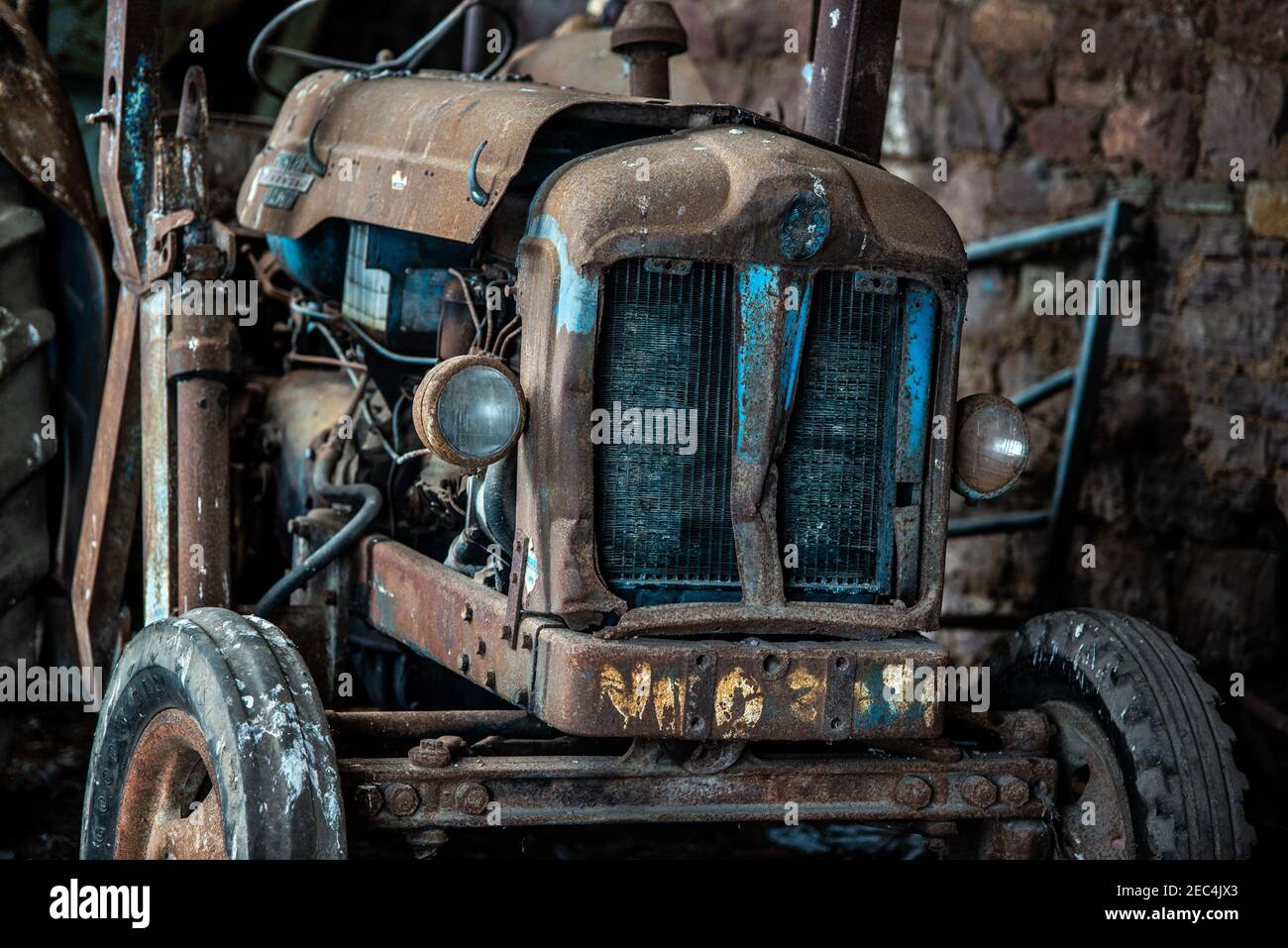 Ein altes Fordson Power Major, das zwischen 1958 gebaut wurde Und 1961 suchen traurig und vernachlässigt in einem alten Bauernhof Gebäude Stockfoto