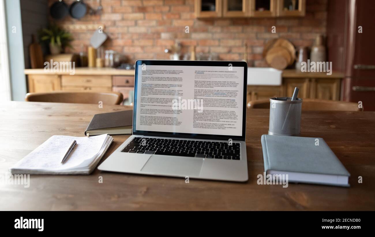 Nahaufnahme moderner Laptop auf Holztisch mit Notizbüchern stehend Stockfoto