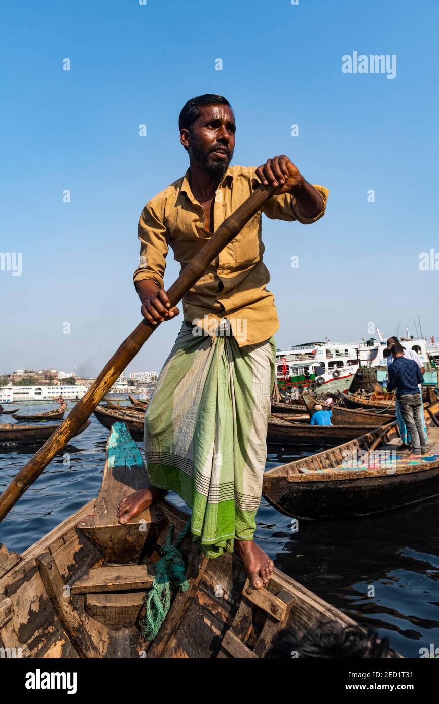 Mann rudert sein Boot, Hafen von Dhaka, Bangladesch Stockfoto
