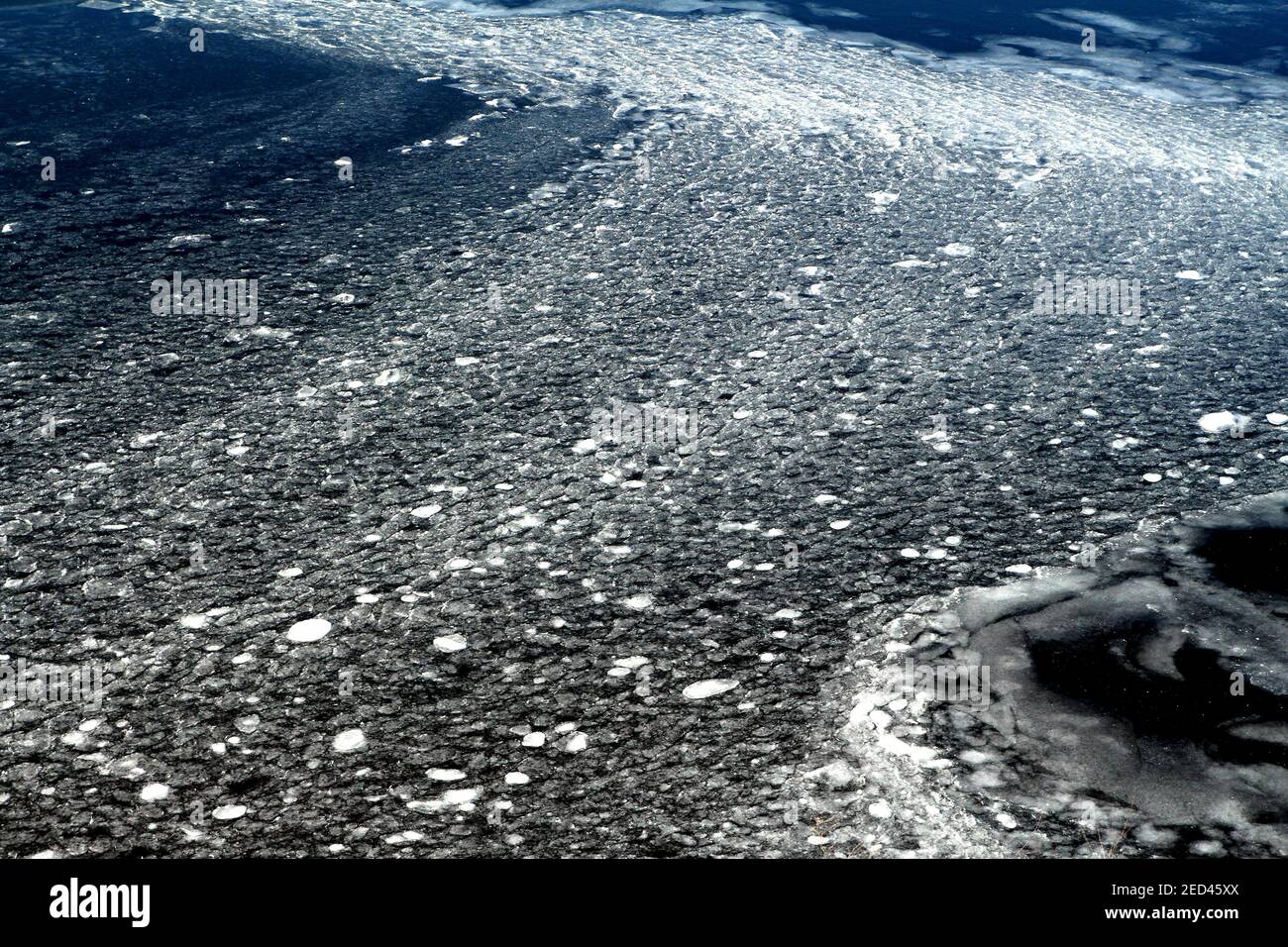 Wasseroberfläche mit Eis bedeckt. Eisiges Wasser. Stockfoto