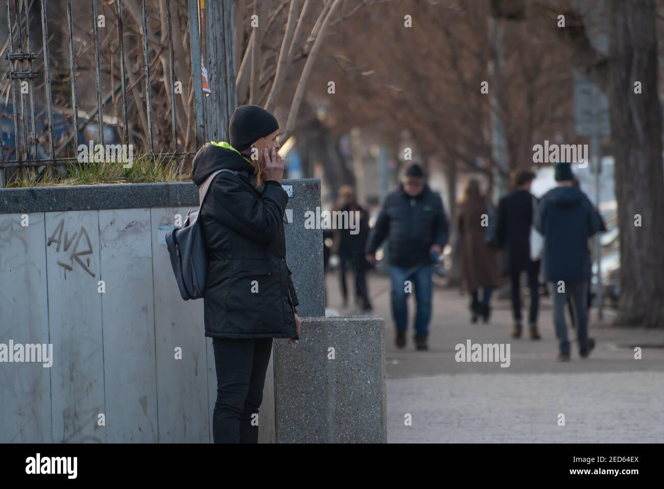 Prag, Tschechische Republik. 02-13-2021. Der junge Mann raucht an einem kalten Wintertag auf der Straße im Stadtzentrum von Prag. Stockfoto