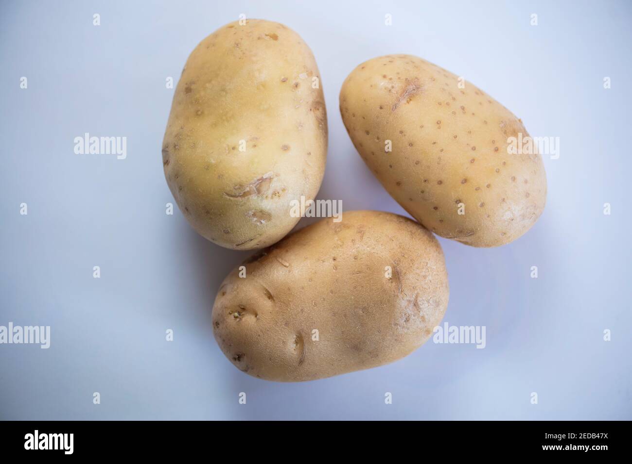 3 Kartoffeln auf weißem Hintergrund Stockfoto