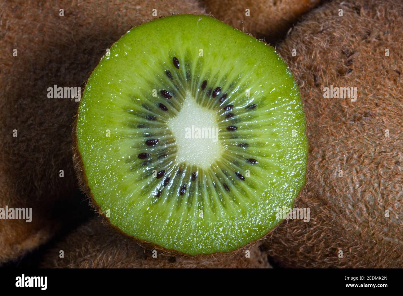 Nahaufnahme Makro-Foto von Vivid Kiwi Slice auf einem Haufen Stockfoto