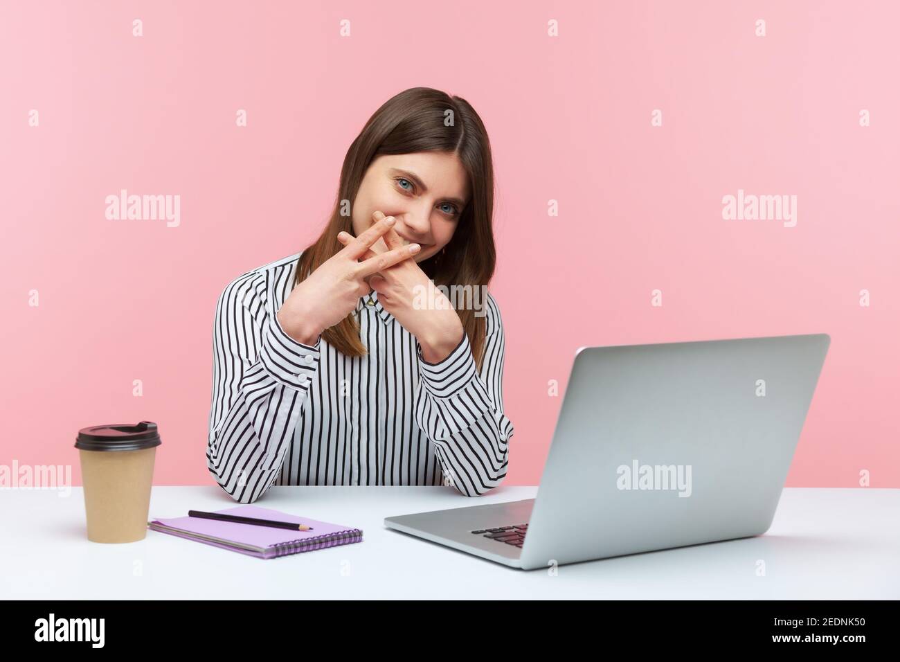 Lächelnd positive Frau Büroangestellte zeigt Hashtag Zeichen mit Fingern sitzen am Arbeitsplatz, halten eigenen Blog, Tagging Post für einfache Suche. Innenst Stockfoto