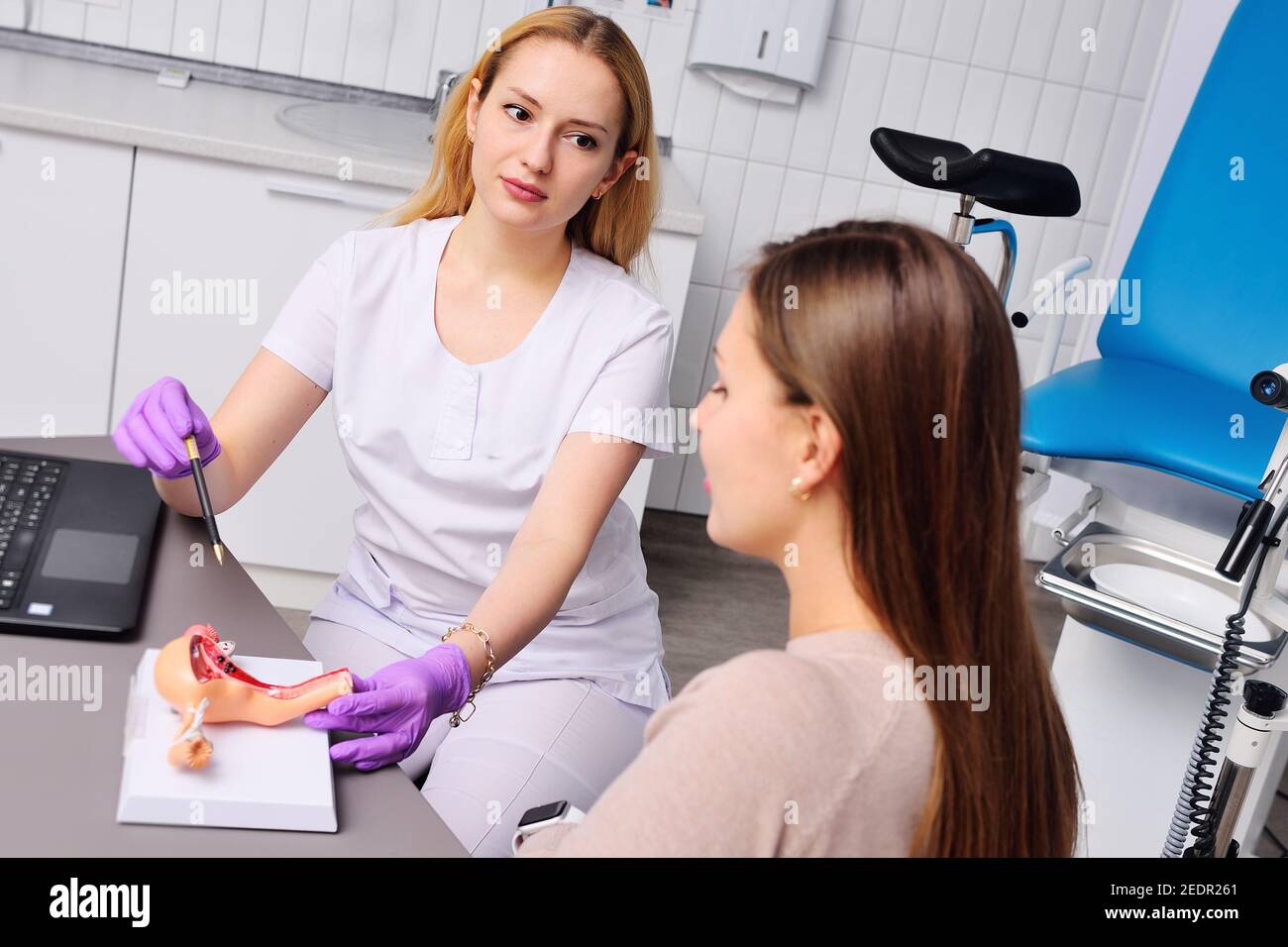 Ein junges attraktives Mädchen bei einer Frauenberatung mit einem Gynäkologen. Stockfoto