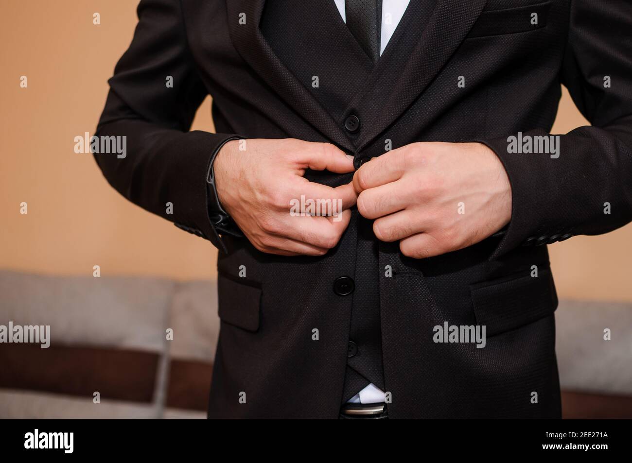 Der Bräutigam knöpfte seine Jacke Stockfoto