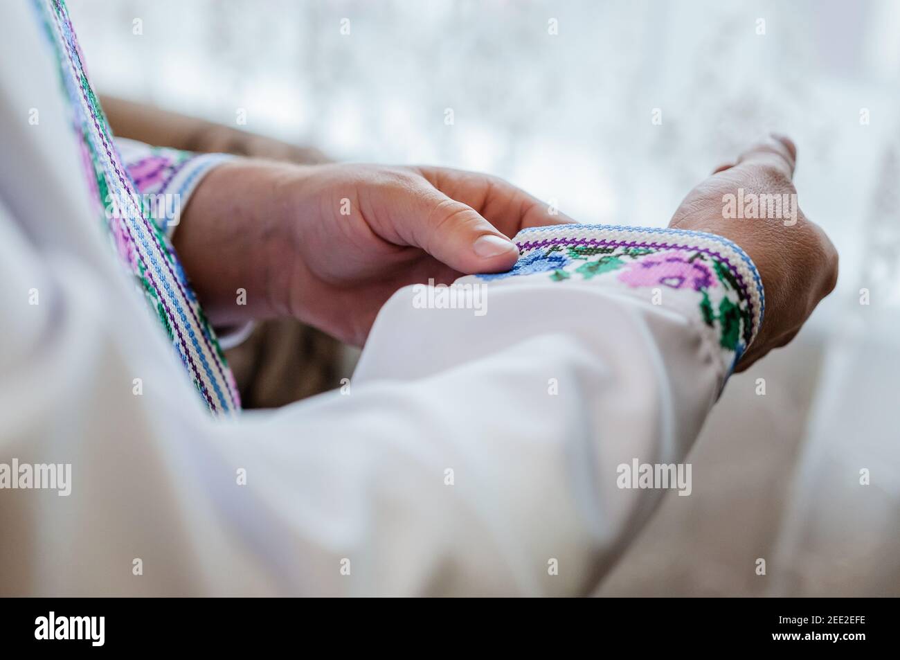 Der Bräutigam befestigt einen Knopf auf dem Ärmel seines hemd Stockfoto
