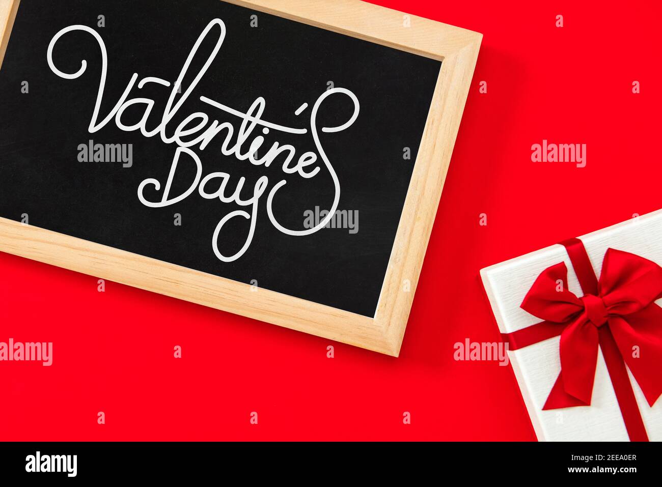 Valentinstag Grußtext in Tafel mit Geschenkbox an Roter Hintergrund Stockfoto