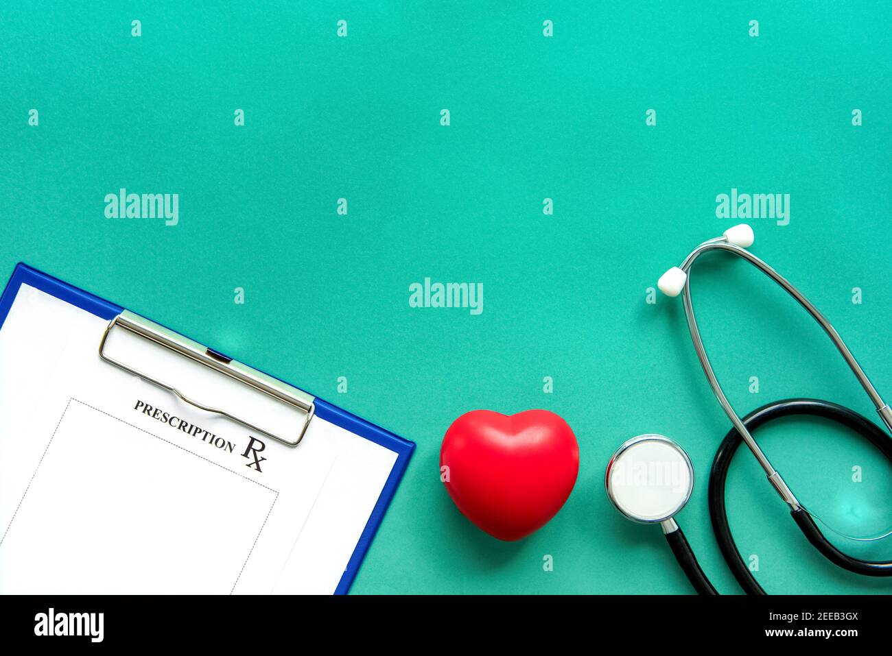 Stethoskop, rx Rezept und rote Herzform Ball auf grünem Papier, medizinische Hintergrund Draufsicht mit Kopierraum Stockfoto