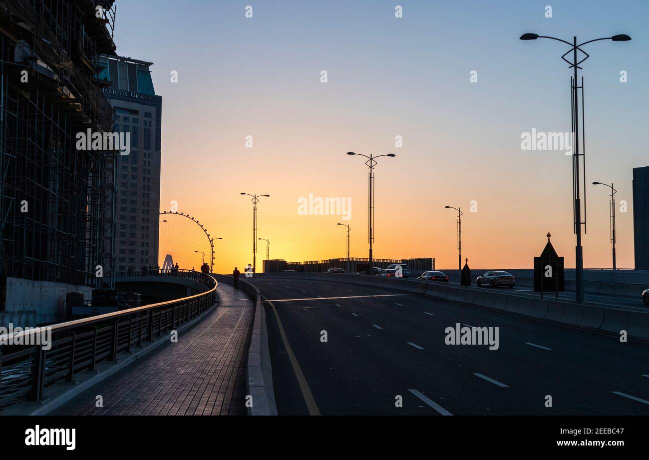 Dubai, VAE - 02.14.2021 dramatischer Sonnenuntergang in Dubai Marina, Teilansicht eines Ain Dubai, größtes Riesenrad der Welt. Im Freien Stockfoto