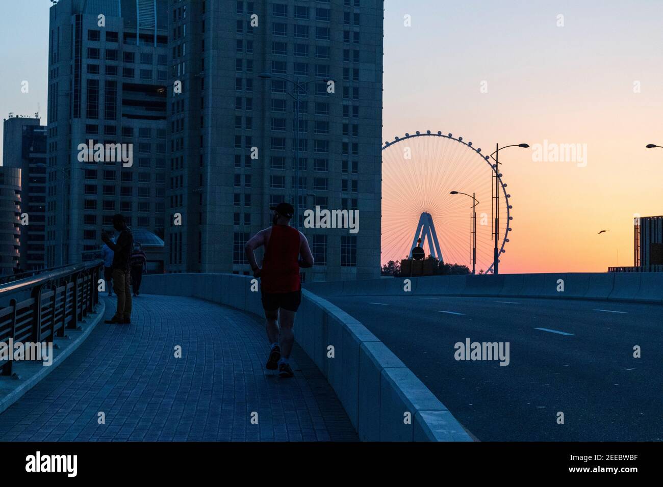 Dubai, VAE - 02.14.2021 dramatischer Sonnenuntergang in Dubai Marina, Teilansicht eines Ain Dubai, größtes Riesenrad der Welt. Im Freien Stockfoto