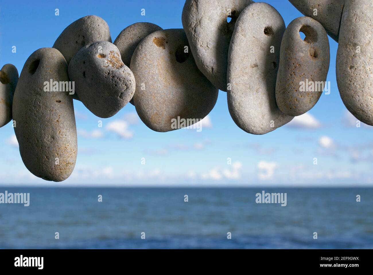 Kieselsteine in Luft mit Meer im Hintergrund Stockfoto