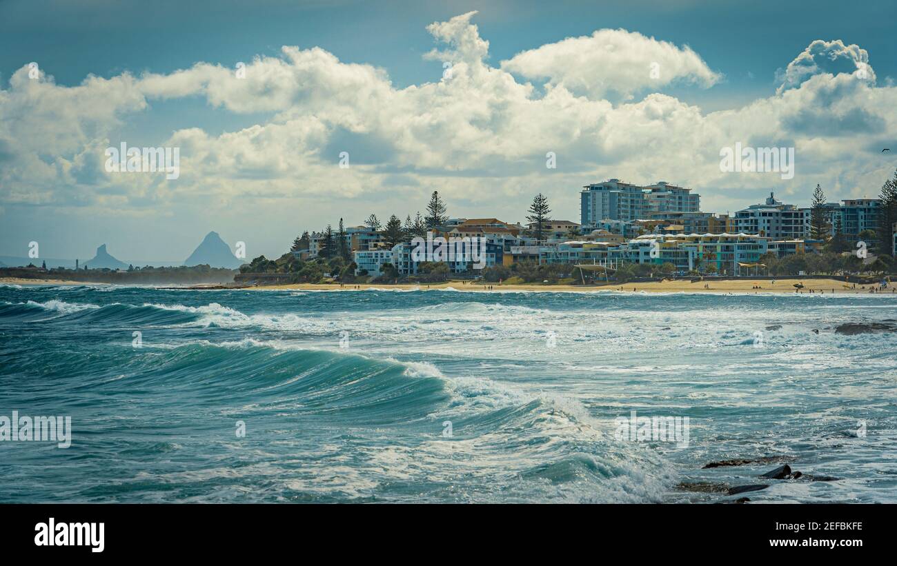 Starke Wellen am Kings Beach in Queensland, Australien mit Glass House Bergen im Hintergrund Stockfoto