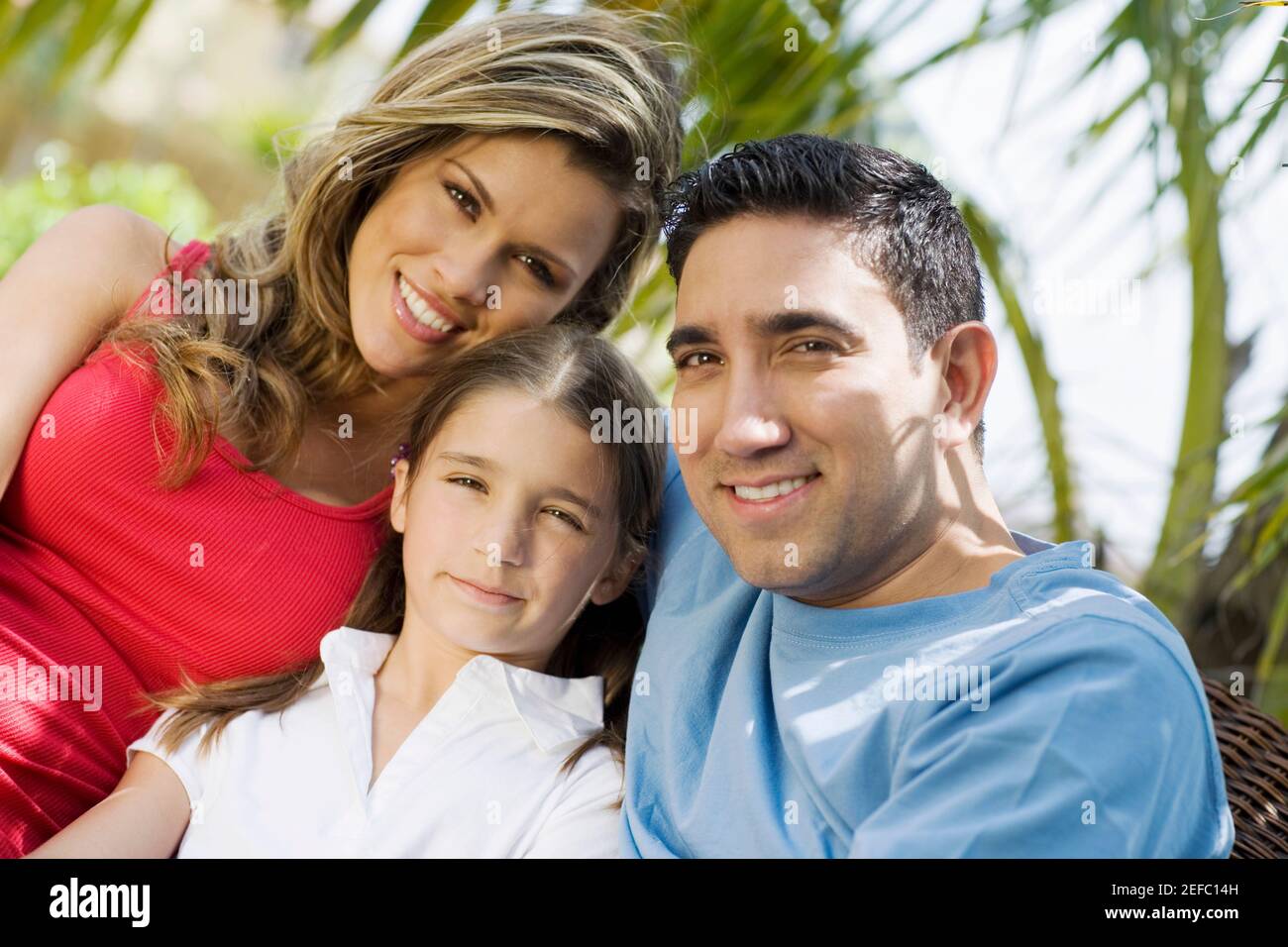 Porträt eines mittleren erwachsenen Mannes und einer jungen Frau Lächelnd mit einem Mädchen Stockfoto