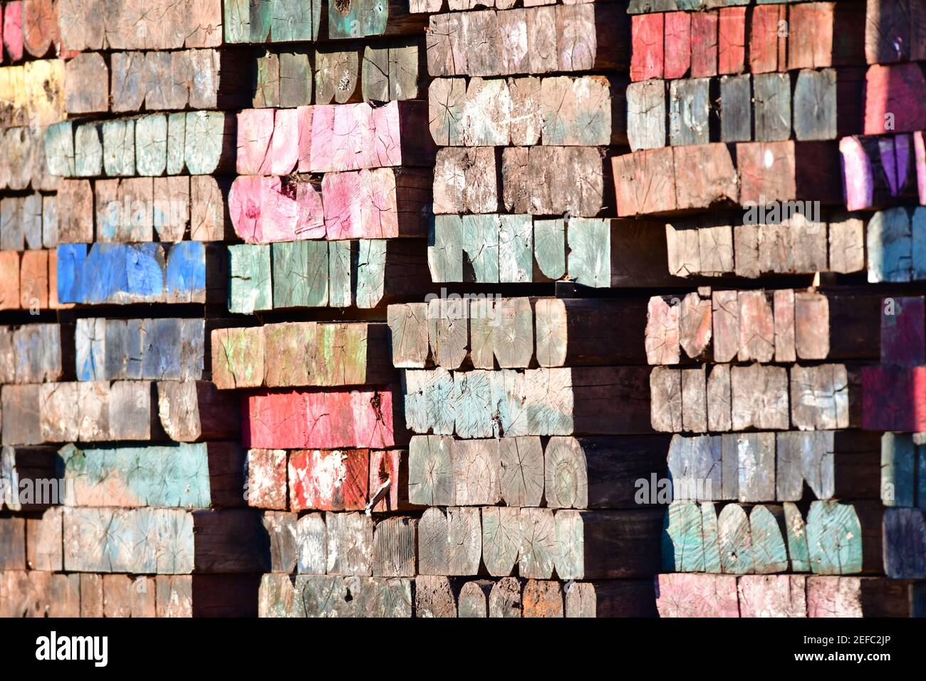 Lebendige Mehrfarbige Holz Mosaik Lackiert Gealterte Verwitterte Industrie Balken. Stockfoto